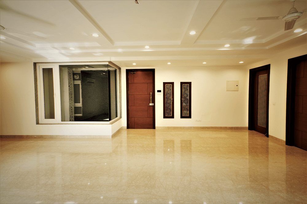 Panchsheel Enclave living area with glass display nook